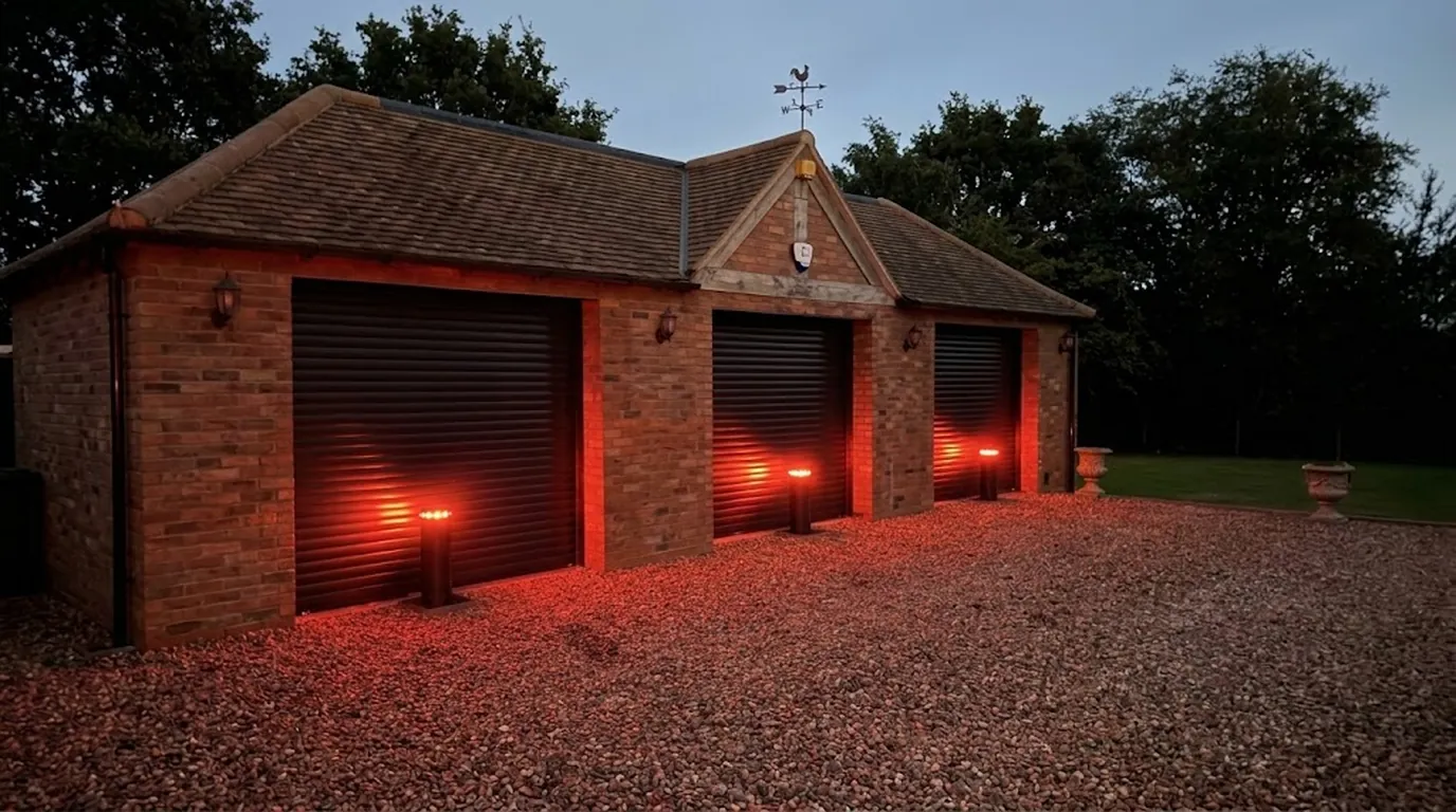 Automatic bollards with red lights outside a garage