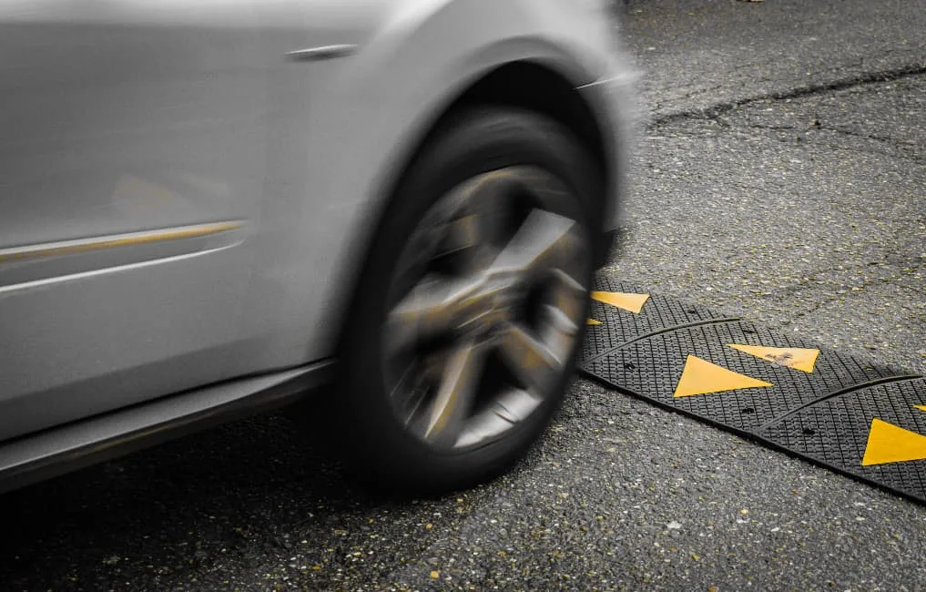 car driving over traffic calming speed ramp